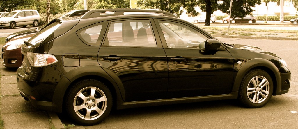 A black Subaru car parked in reverse.