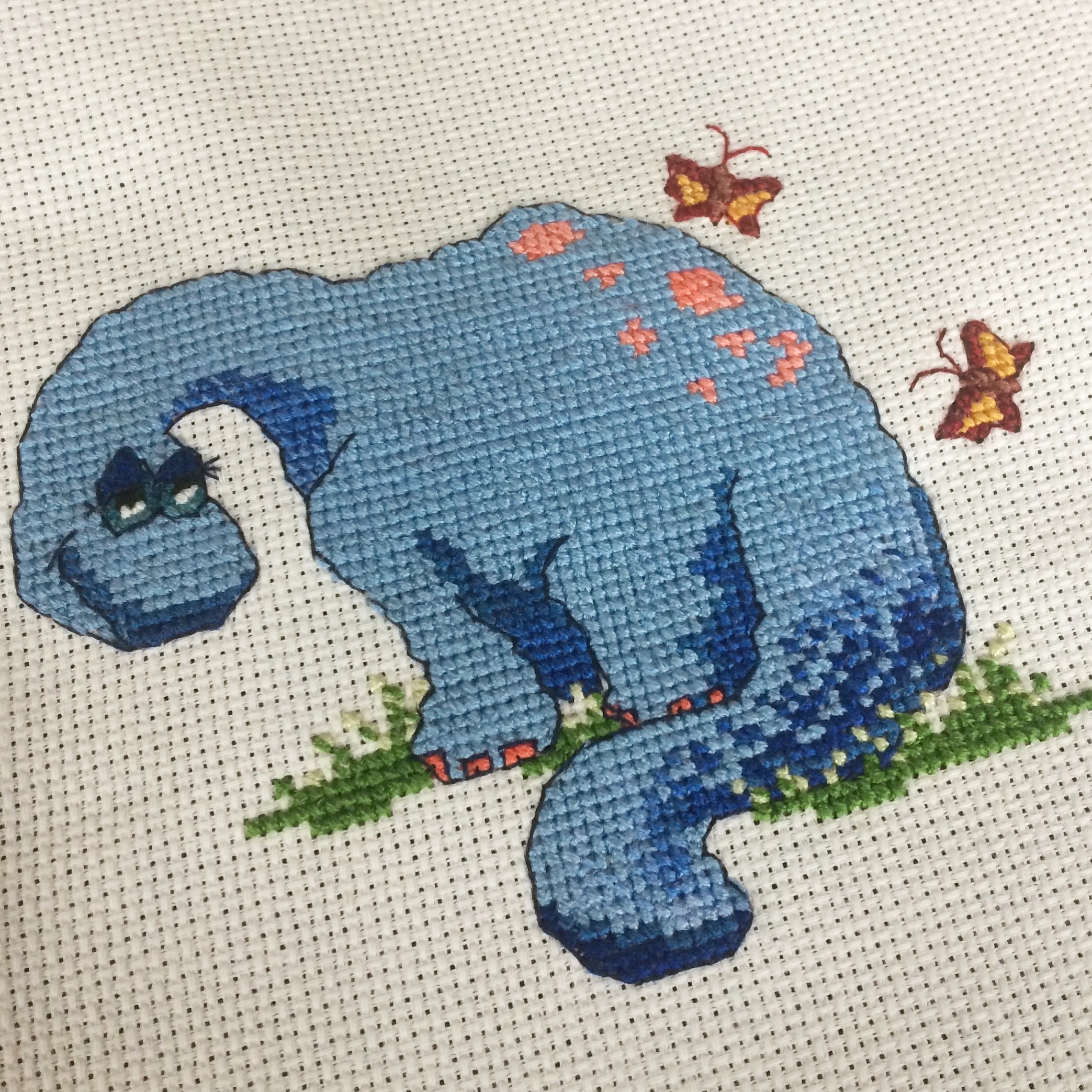 A dinosaur cross-stitch