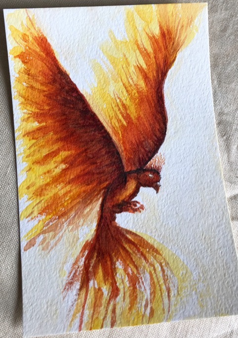 A red and orange phoenix is painted in watercolour on textured cotton paper
