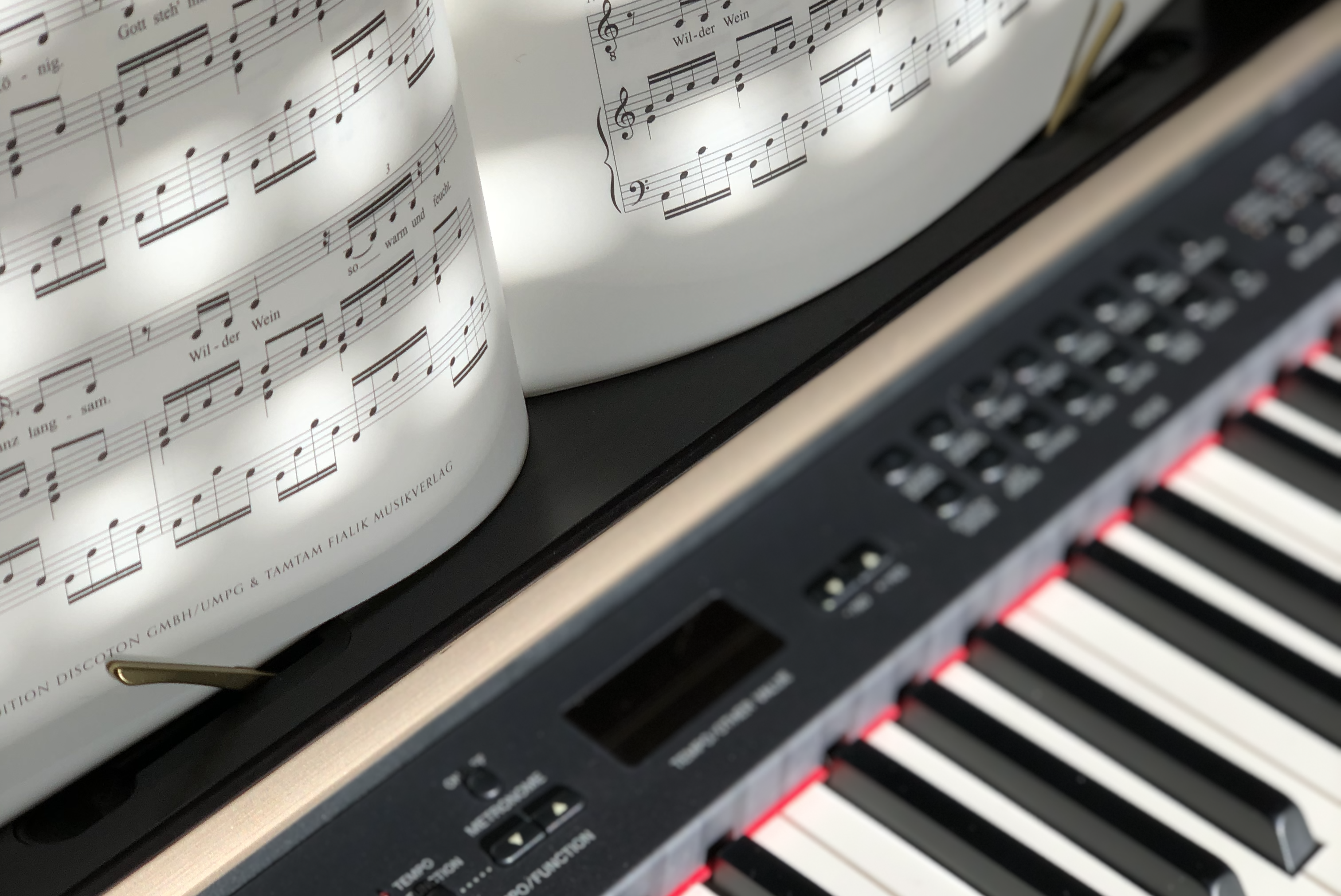 An electric piano with an open piece of music awaiting the pianist